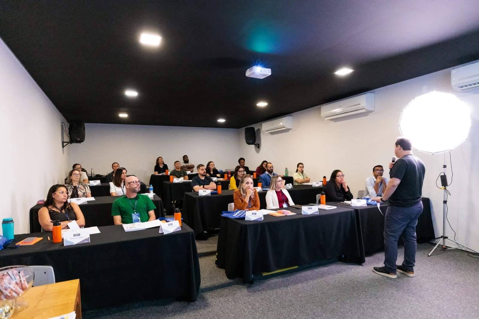 Auditório Minions em Campinas preparado com mesas, cadeiras e projeção para um evento corporativo